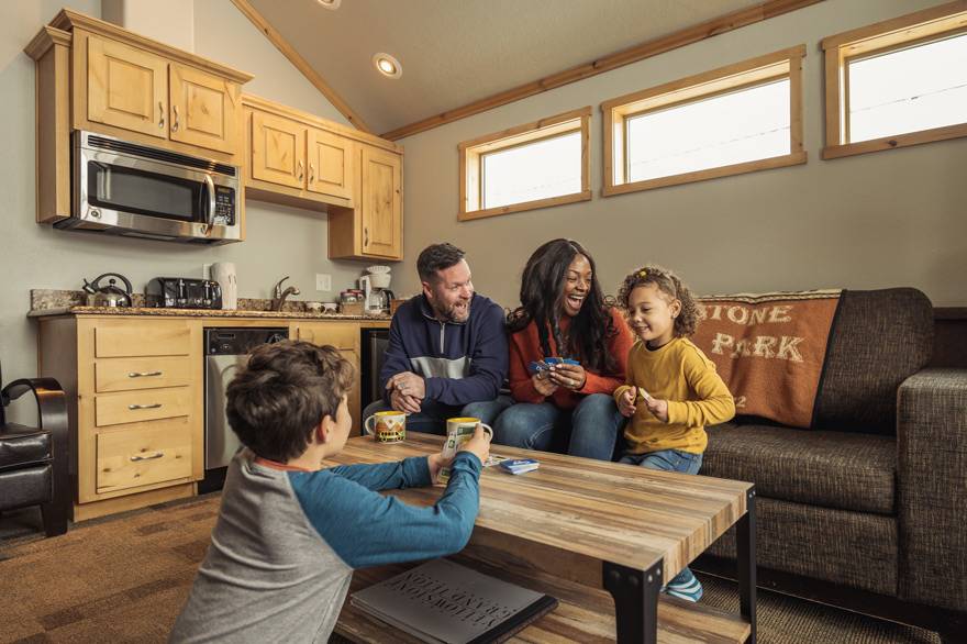 A family playing cards in the Explorer Cabins at Yellowstone