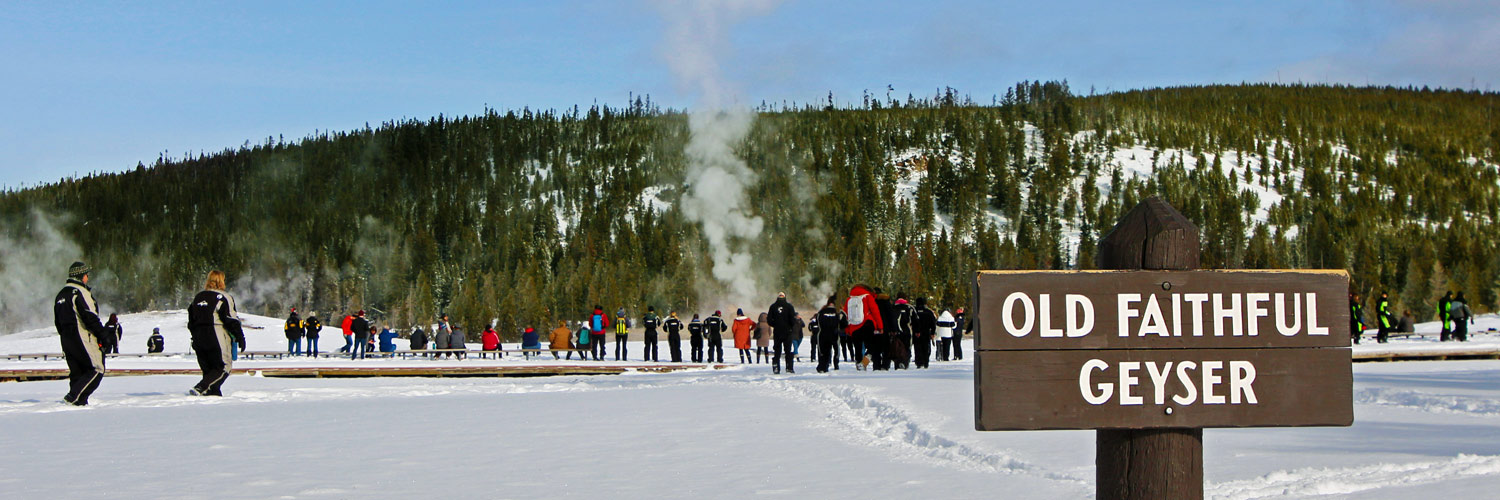 Yellowstone visitors exploring Old Faithful in winter