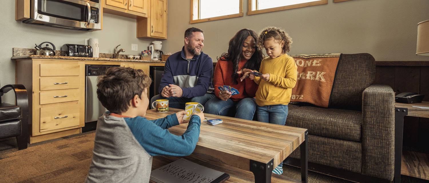 A family playing cards in West Yellowstone's Explorer Cabins