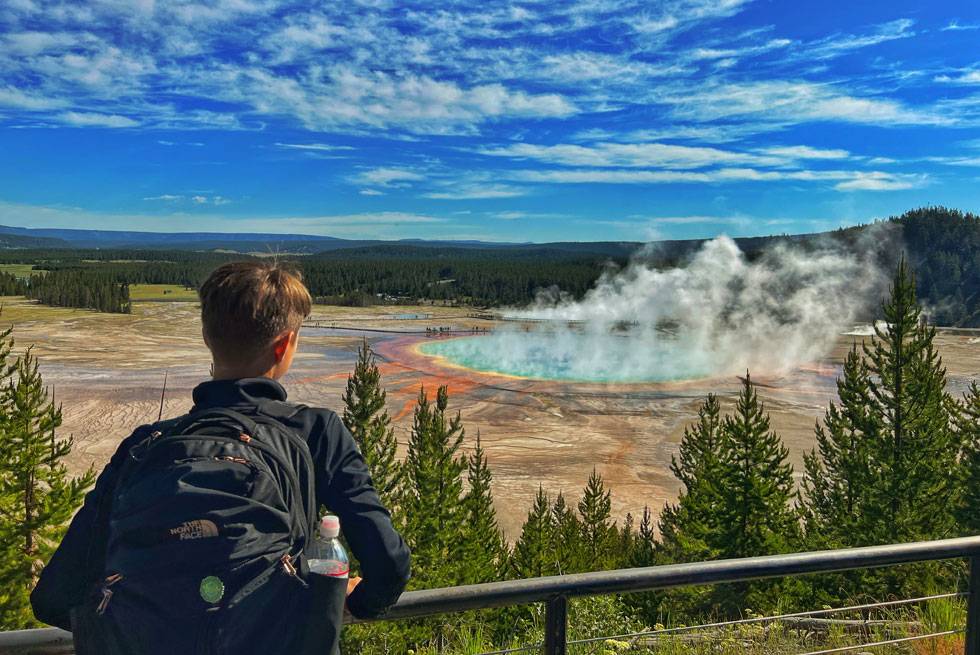 A Yellowstone National Park visitor checking out Grand Prismatic Spring