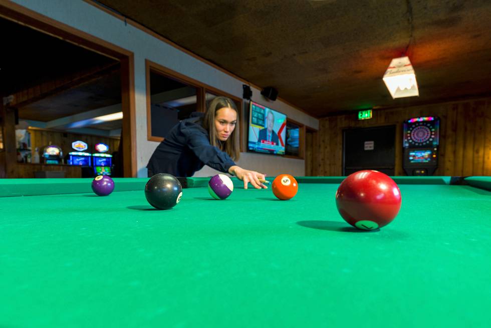 A guest shooting pool at The Yellowstone Mine Restaurant and Bar
