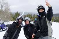 A group of Yellowstone snowmobilers stops to take a selfie
