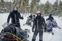 A group of Yellowstone snowmobile riders poses for a photo