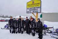 A group of snowmobile riders getting ready for their tour of Yellowstone with Yellowstone Vacation Tours