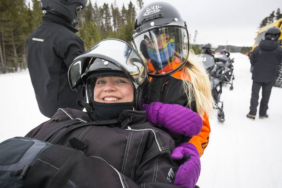 A mother and daughter on a Yellowstone snowmobile tour