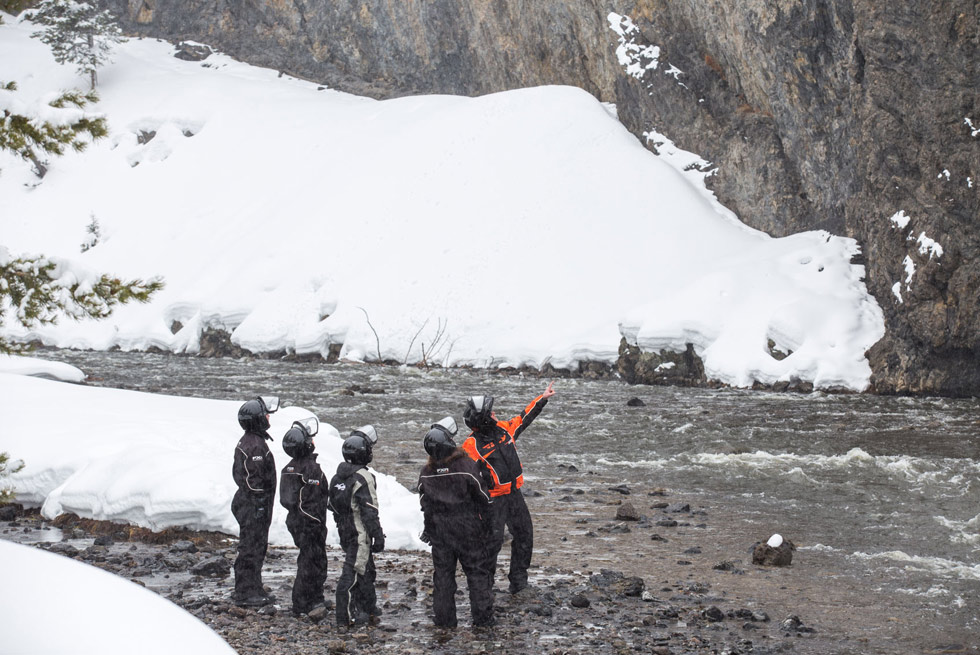 A Yellowstone snowmobiling guide shows some geological features to his group.