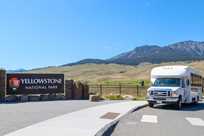 A Yellowstone Vacation Tours bus at the north entrance to Yellowstone National Park