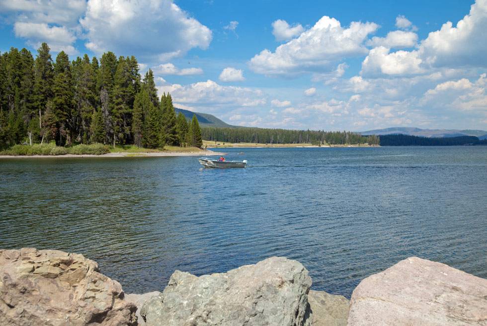 A boater on Yellowstone Lake, seen from one of our Summer Bus Tours